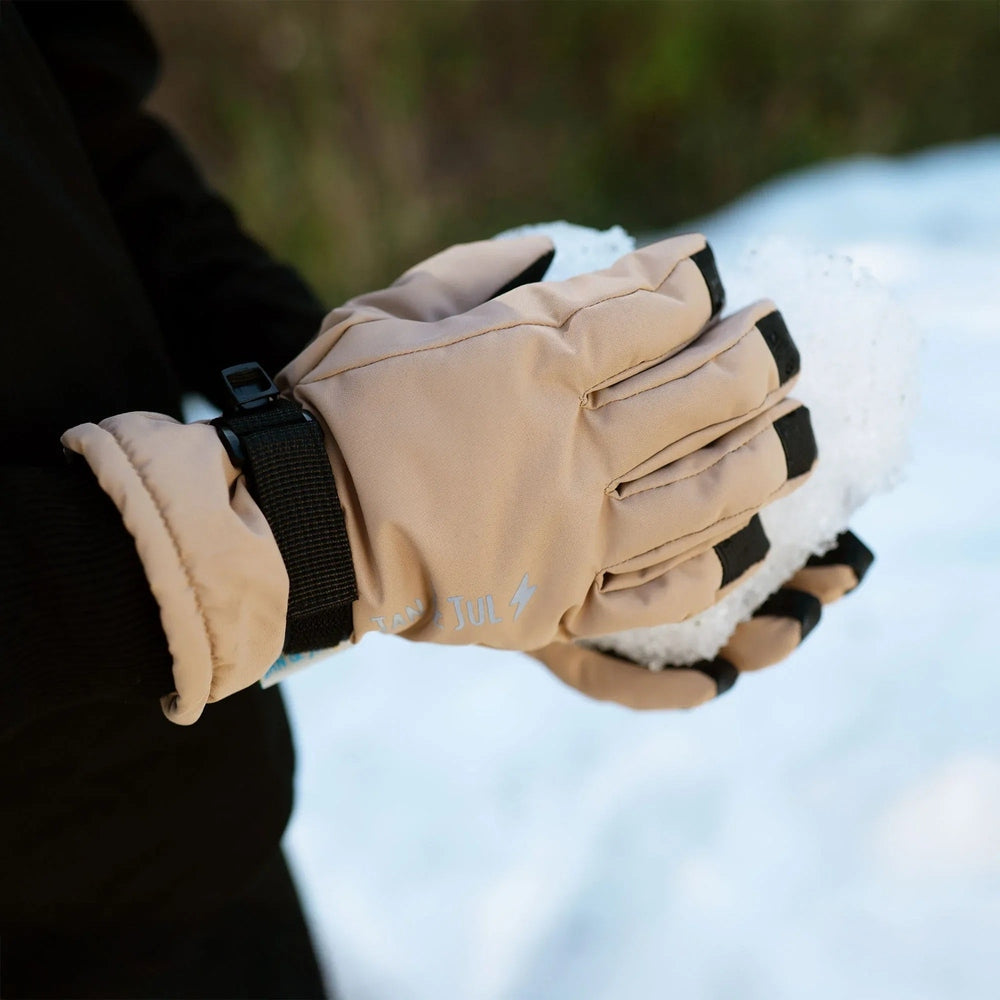 Jan & Jul Kids Waterproof Snow Gloves in soft brown, gripping a snowball to show waterproof warmth.