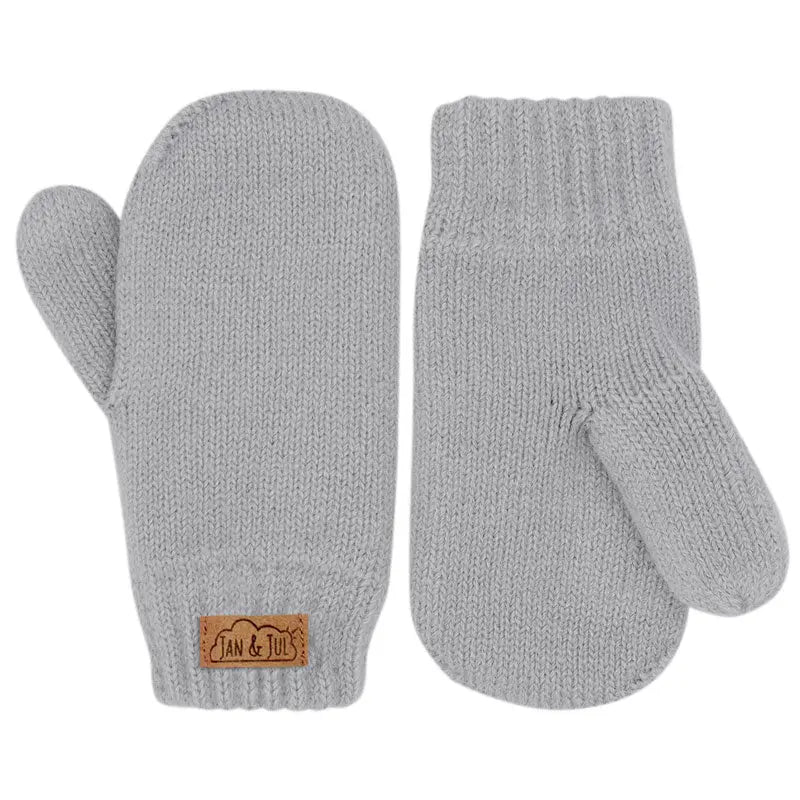 Jan & Jul Knit Mittens Grey, a pair of cozy baby mittens laid flat with the brand tag visible.