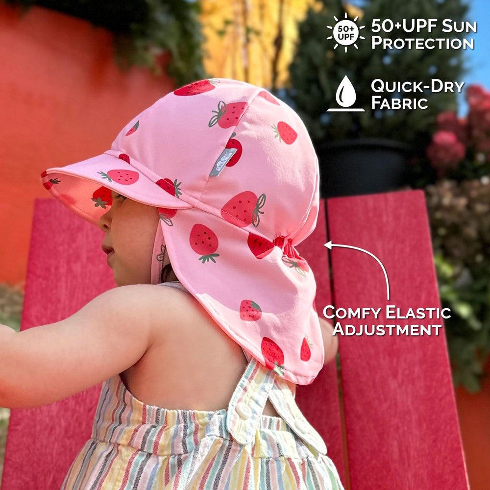 Jan & Jul Sun Soft UV Baby Cap Pink Strawberry on a toddler outdoors; elastic back adjuster and UPF 50+ quick-dry fabric