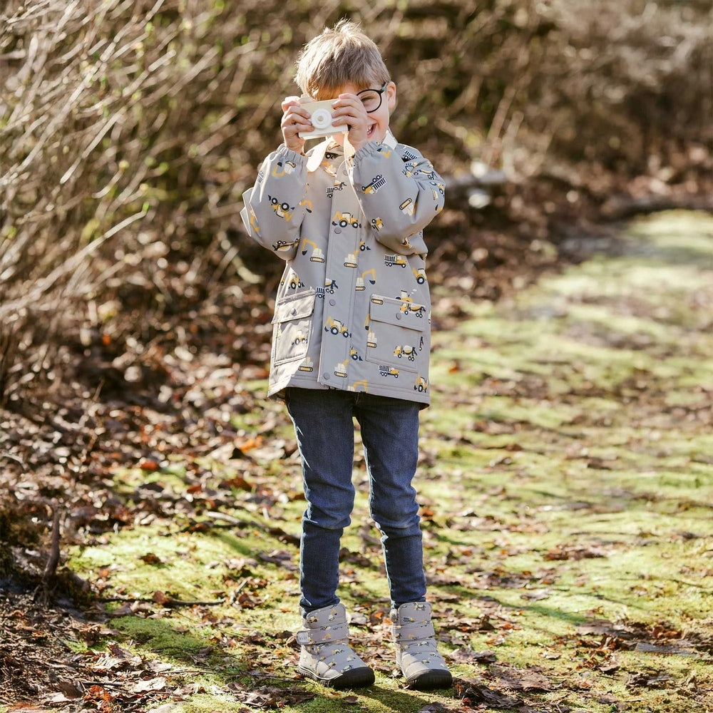 JAN & JUL Toasty Dry Booties Grey Construction; toddler outdoors wearing warm, durable boots with grippy soles.