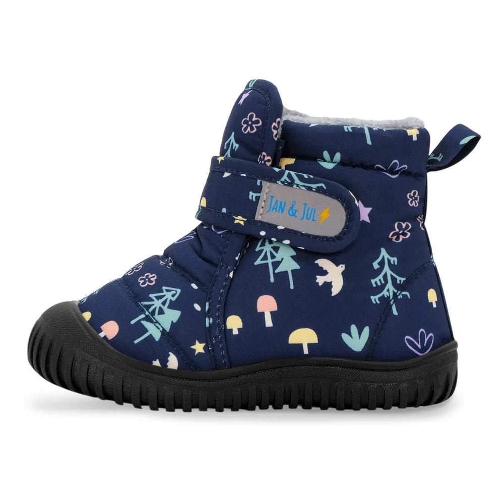 Jan & Jul Toasty Dry Booties Navy Forest, navy woodland print with warm lining and Velcro strap fastened.