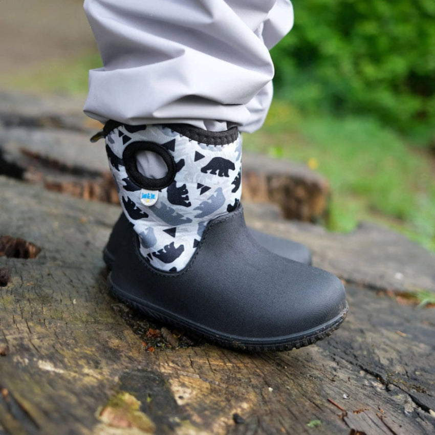 Jan & Jul Toasty Dry Lite Winter Boots Bear Cub; toddler boot with black waterproof lower and gray bear-print upper worn on a foot.