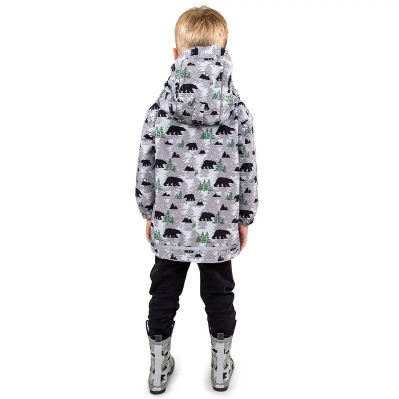 Jan & Jul Waterproof Cozy Dry Rain Jacket Bear, grey hooded kids coat with bear/tree print; child stands with back to camera.