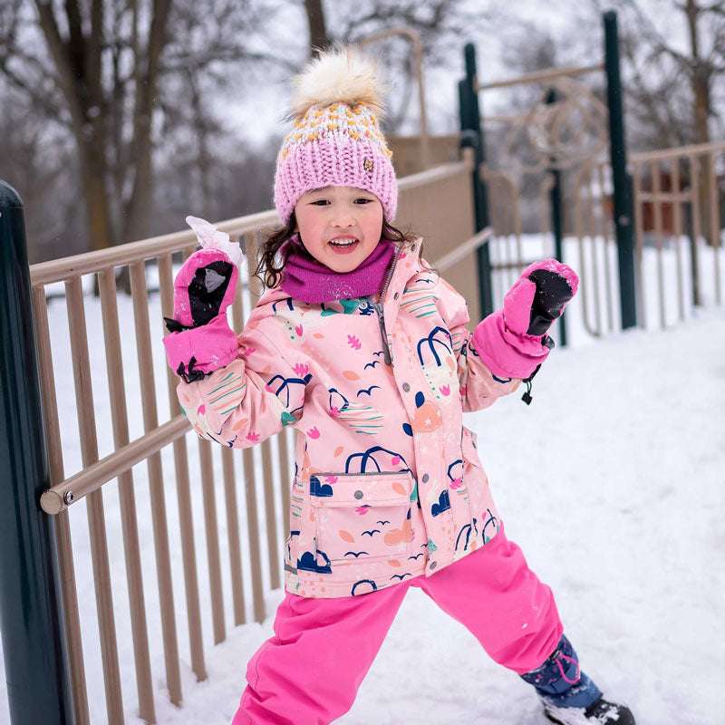 JAN & JUL Dreamscape waterproof rain jacket worn by a child in a pink printed coat with matching pink pants