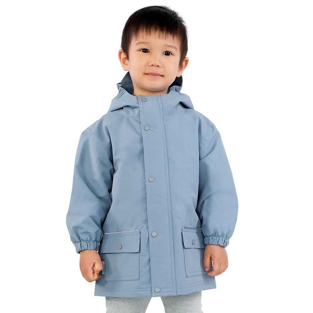 Jan & Jul Waterproof Cozy Dry Rain Jacket Dusty Blue worn by a child, hooded with snap front and two pockets