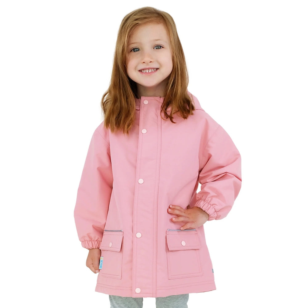 Jan & Jul Waterproof Cozy Dry Rain Jacket Dusty Pink worn by a smiling girl, featuring front snap placket and pocket flaps.