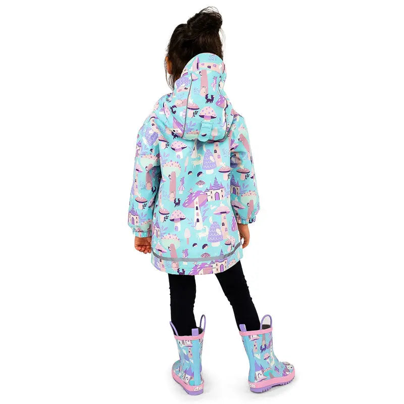 Jan & Jul Waterproof Cozy Dry Rain Jacket Enchanted worn by a child in turquoise pastel print, hood up, matching boots.
