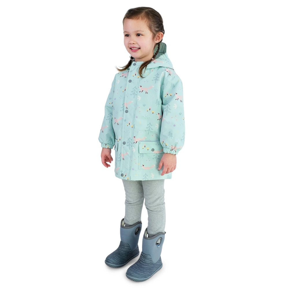 Jan & Jul Waterproof Cozy Dry Rain Jacket Minty Forest, minty green hooded coat worn by a smiling girl standing.