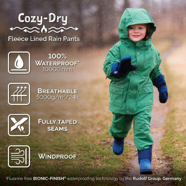 Jan & Jul Waterproof Cozy Dry Rain Pants Constellations; green fleece-lined toddler rain pants worn by a child, showing taped seams