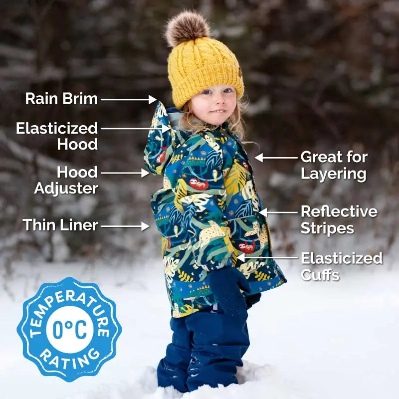 JAN & JUL Jungle Nights Waterproof Puddle Dry Rain Jacket worn by a toddler in the snow, hood up and elastic cuffs secured.