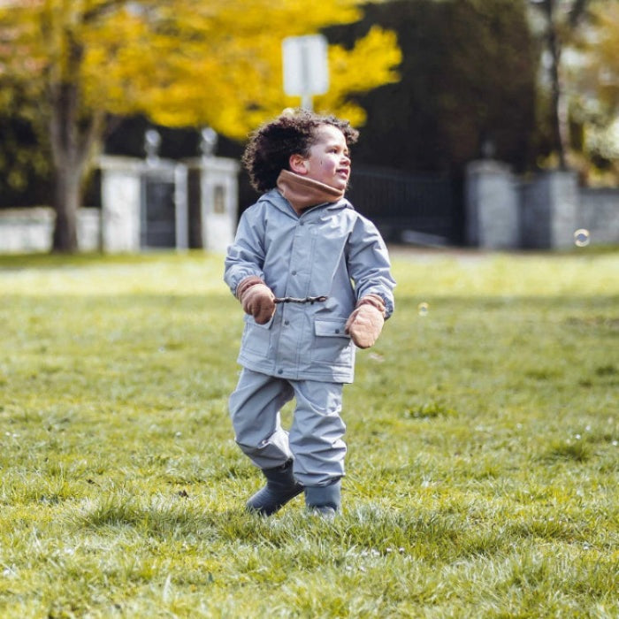 JAN & JUL Waterproof Puddle-Dry Rain Pants Greystone, grey toddler rain pants, child walking on grass.
