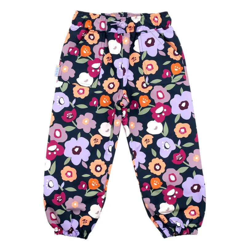 Jan & Jul Waterproof Puddle Dry Rain Pants Winter Flowers laid flat, navy fabric with bright floral print and elastic cuffs.