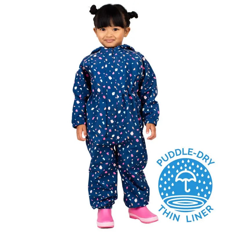 Jan & Jul Waterproof Puddle-Dry Rain Suit Terrazzo blue, worn by a toddler in pink boots, showcasing its thin liner.