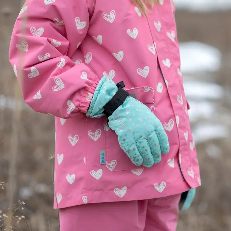 Jan & Jul Waterproof Toasty Dry Snow Gloves Pink Star worn by a child, turquoise star-print cuff with adjustable strap.