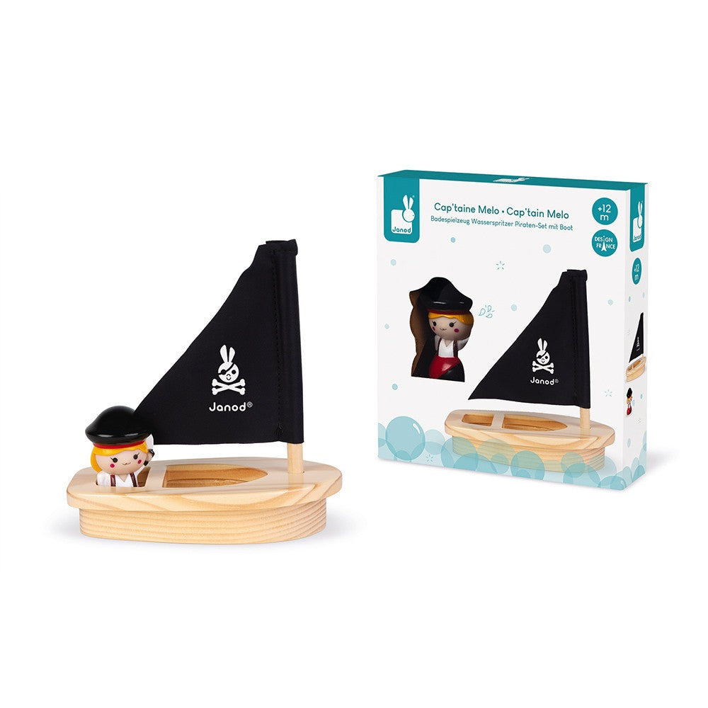 Janod Captain Melo and Her Boat bath toy set with a wooden boat, black sail, and tiny captain figure