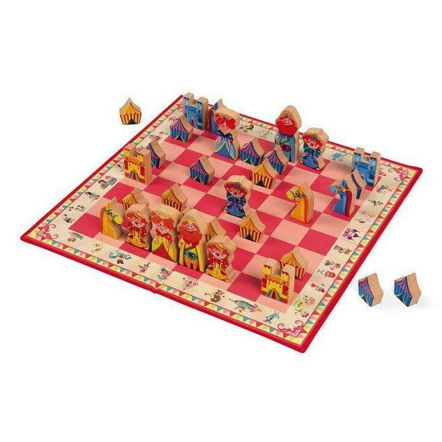 Carrousel Chess Game by JANOD, wooden carousel-themed chess set on a pink checkered board with colorful pieces.