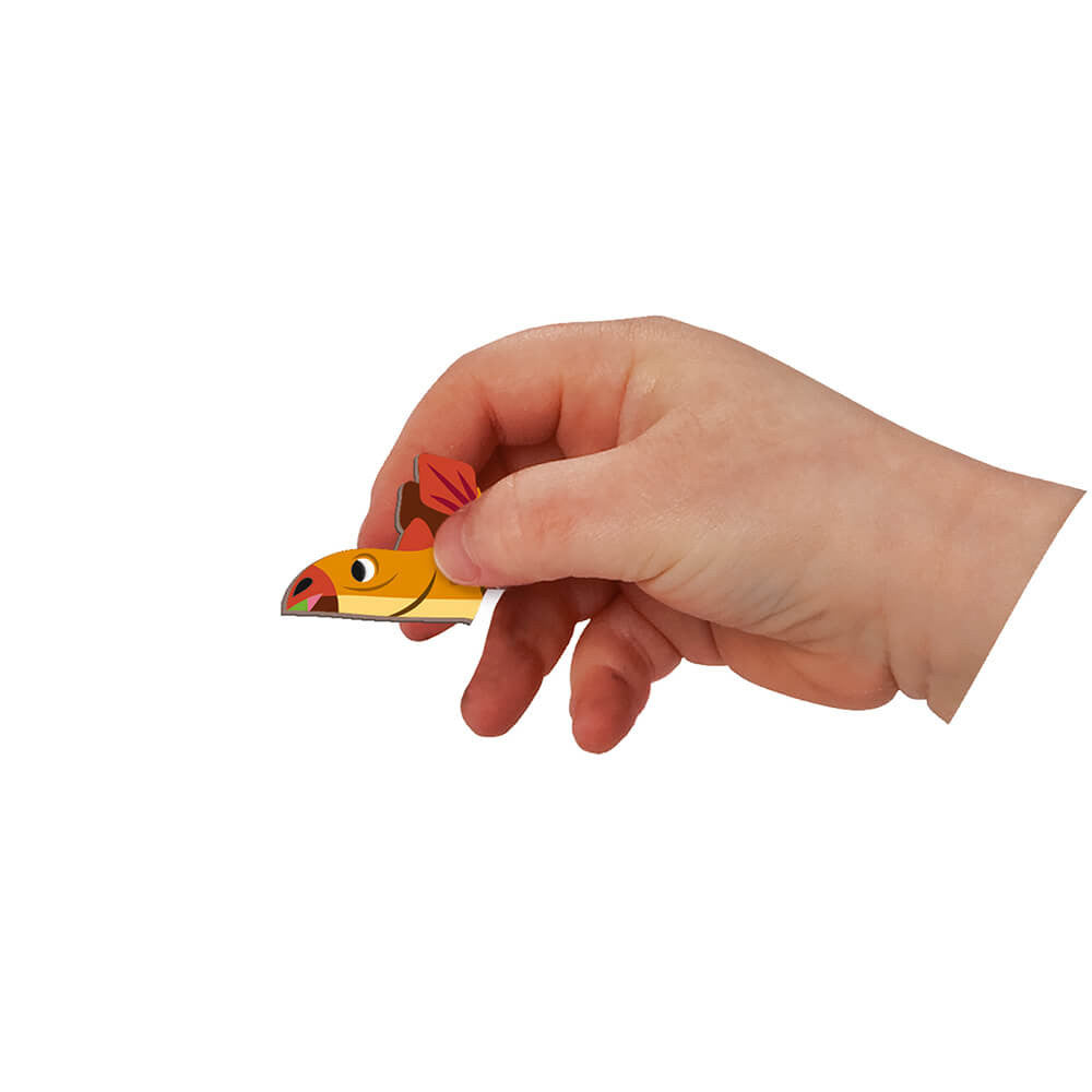 JANOD Magnetibook Dinosaurs magnet piece in orange and yellow held by hand