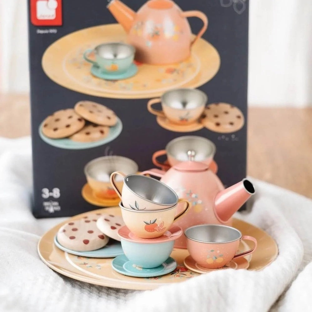 Janod metal tea set with pastel pink teapot, cups and saucers on a round tray with cookies