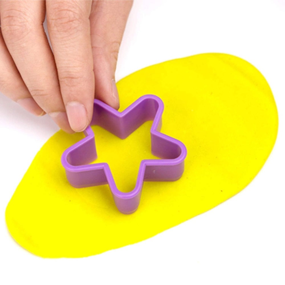 Jar Melo star-shaped dough cutter, purple plastic tool on bright yellow play dough