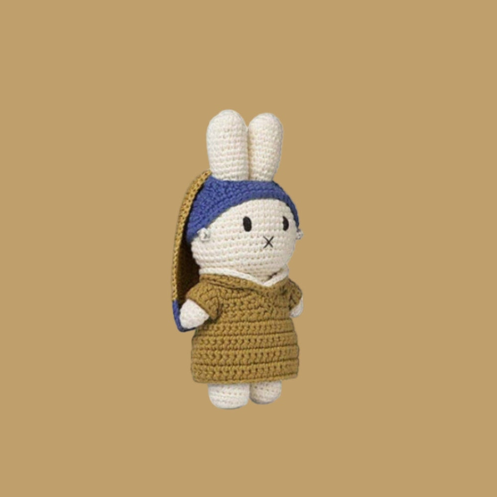 Just Dutch Miffy plush standing upright in a brown crochet dress with blue headband, art-inspired look.