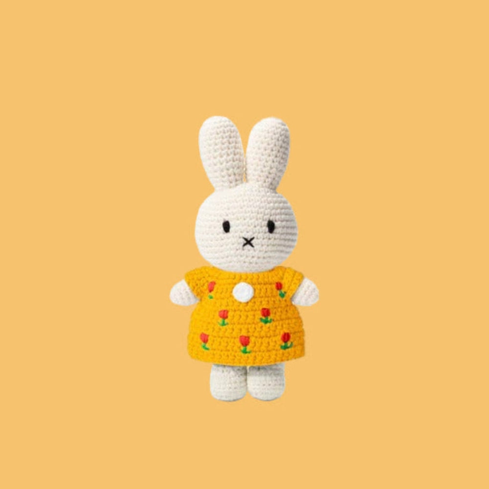 Just Dutch Miffy Tulip Dress Yellow crochet bunny plush wearing a yellow tulip-pattern dress, with arms at sides.