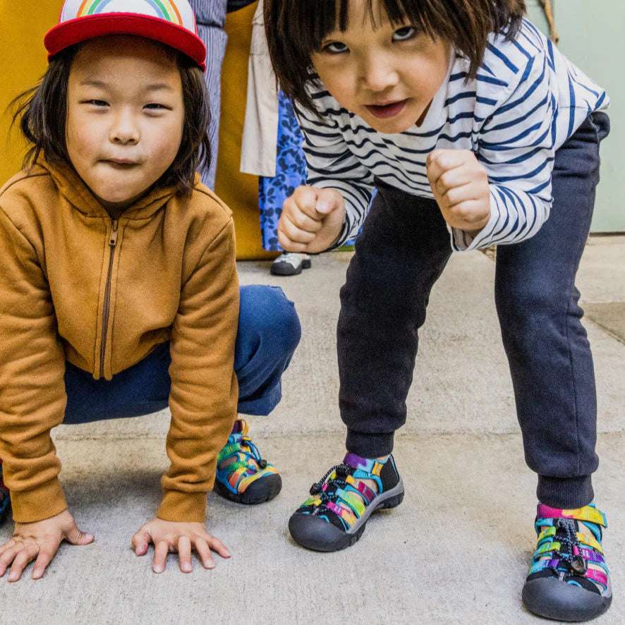 Keen Big Kids Newport H2 sandals; multicolor strap design, worn by two children