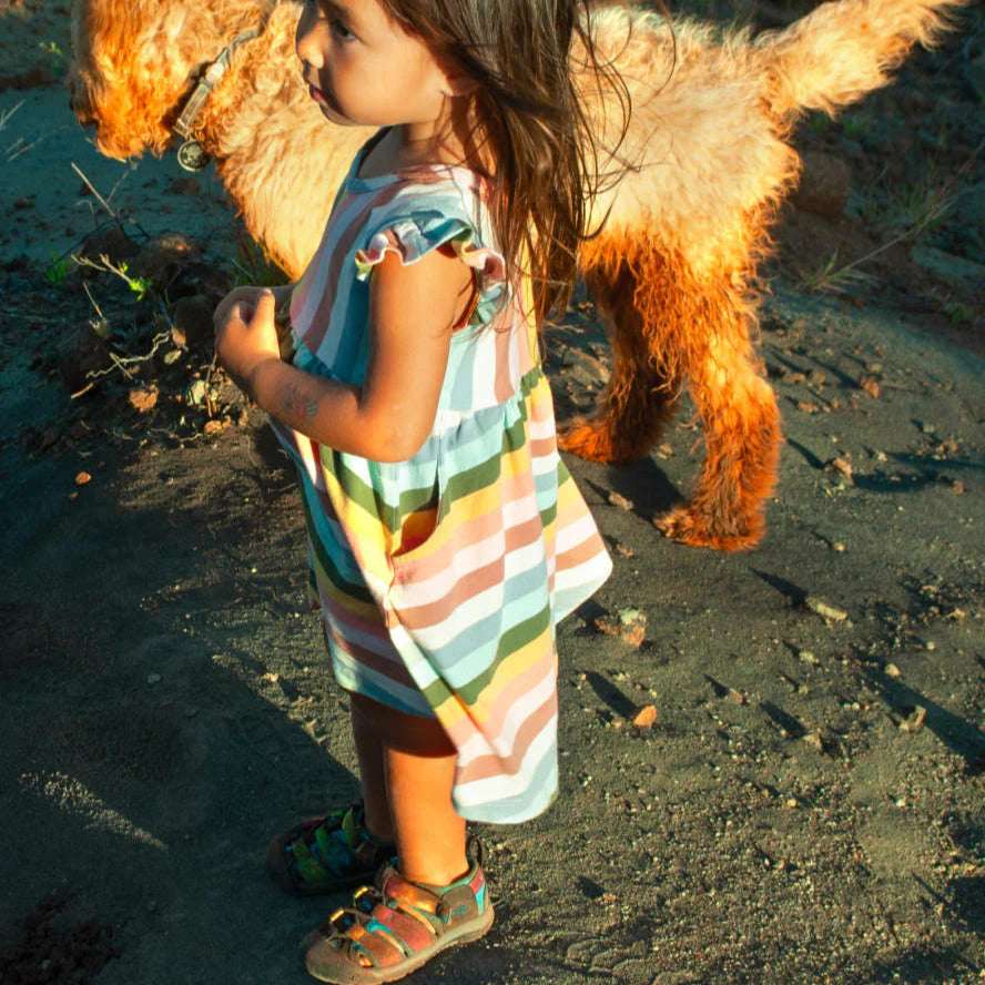 Keen Toddlers Newport H2 sandal on a toddler, multicolor striped straps