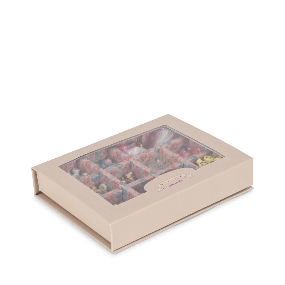 Konges Slojd Abc Jewellery Set in a beige gift box with a clear window showing colorful beads and jewelry pieces.