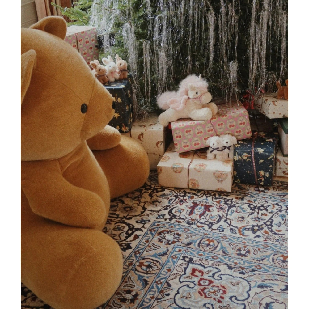 Konges Slojd Baby Animals plush toys—large beige bear plus smaller stuffed friends—displayed among wrapped gifts.