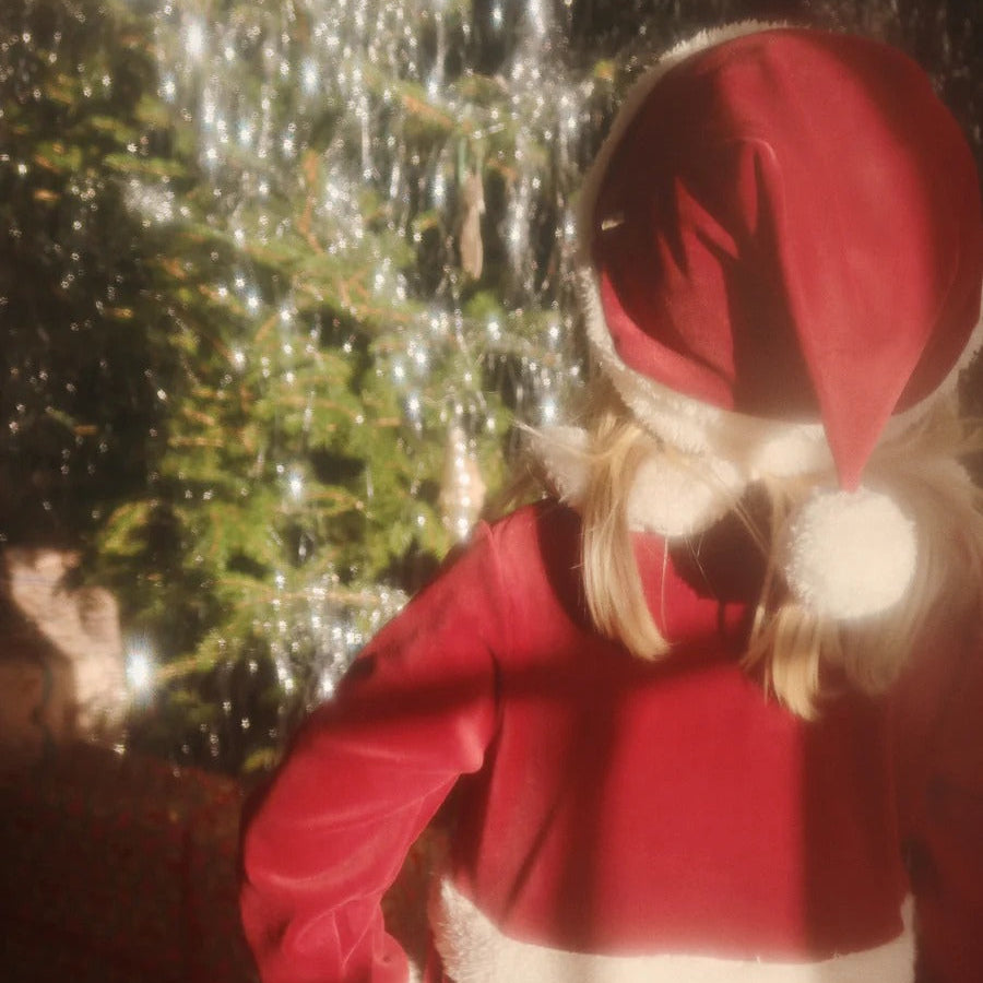 Konges Slojd Christmas Dress Red Dahlia on a toddler, red velvet with white faux fur trim and hood, back view