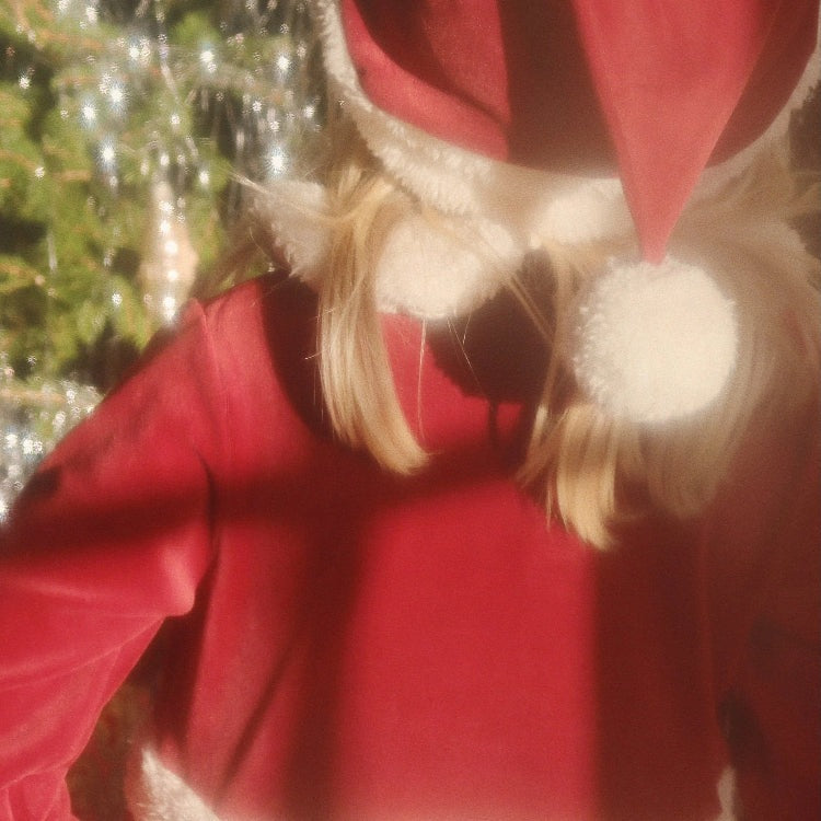 Konges Slojd Christmas Dress Red Dahlia on a toddler, red dress with white faux-fur trim and pom-pom hood.