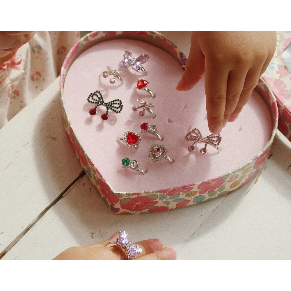 Konges Slojd Dreamy Ring Set 14 Pcs in a pink floral box, where a child picks a lavender butterfly ring.