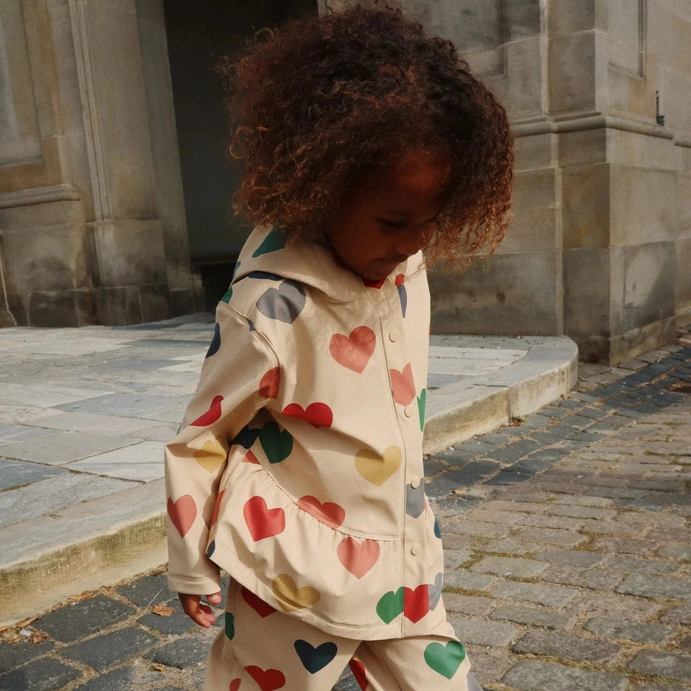 Konges Slojd Faire rain coat and pants set for toddlers in beige with multicolor hearts