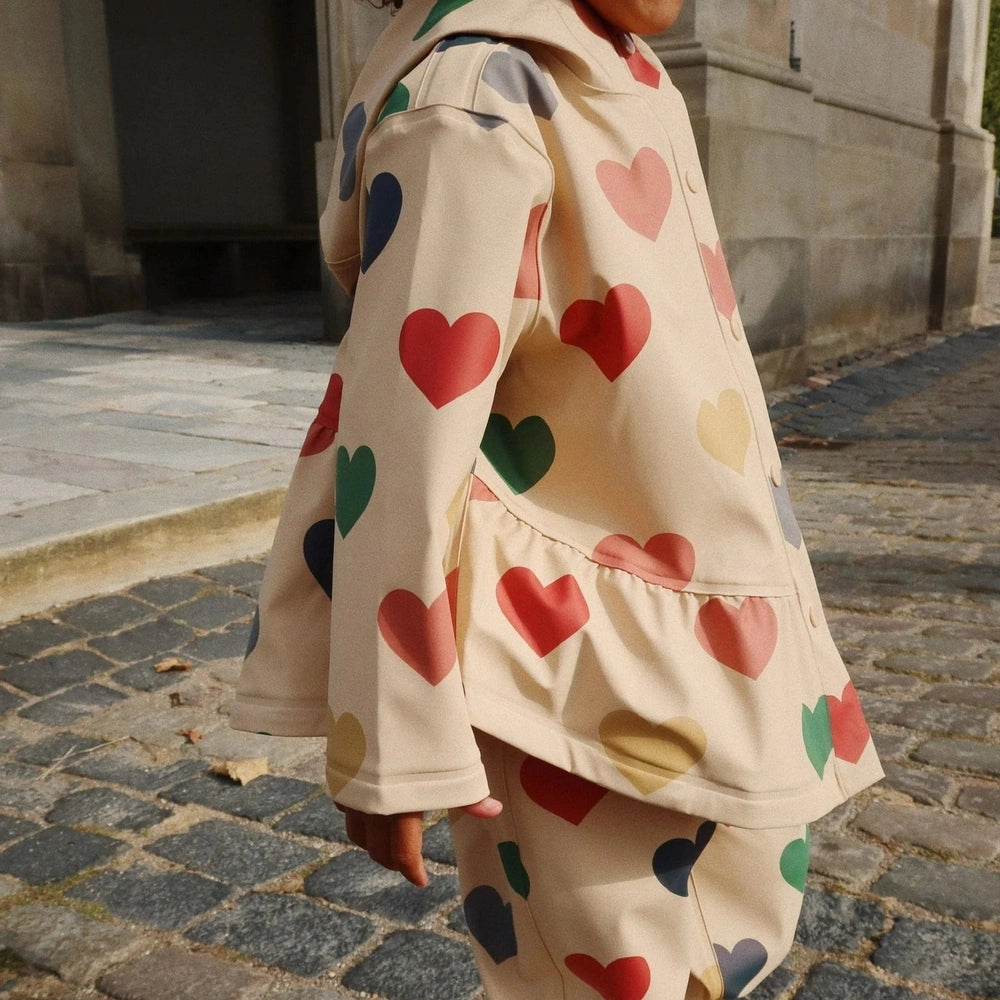 Konges Slojd Faire rain coat and pants set for toddlers in beige with multicolor hearts