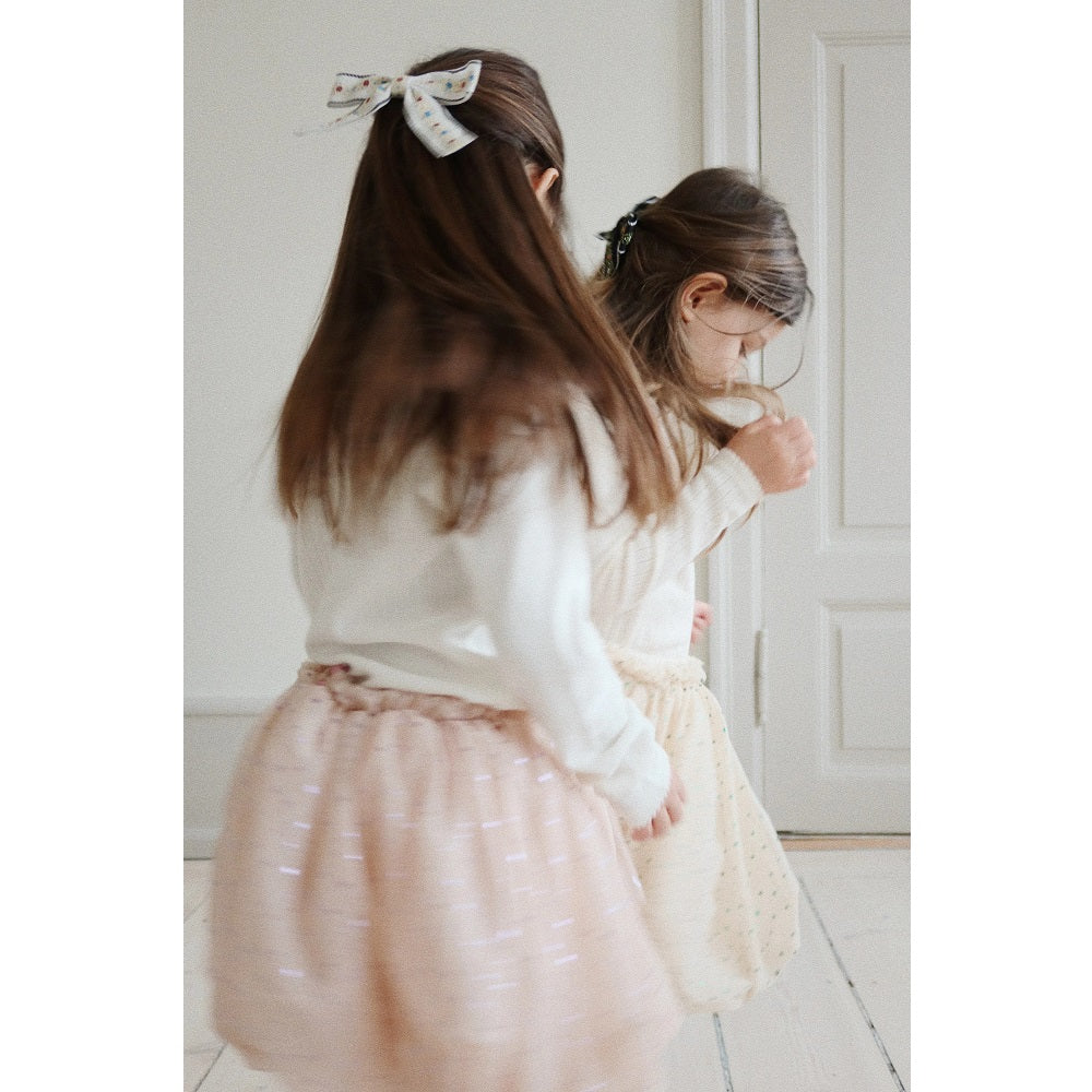 Konges Slojd Fairy Balloon Skirt Fairy Etoile worn by a girl twirling in a pale pink glittery tutu.