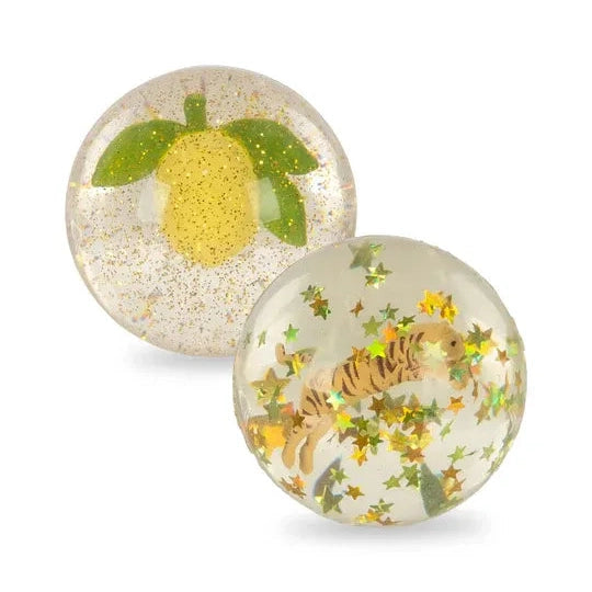 Konges Slojd Glitter Bouncing Ball Set Lemon/Tiger: two clear, glitter-filled balls with lemon and tiger designs.