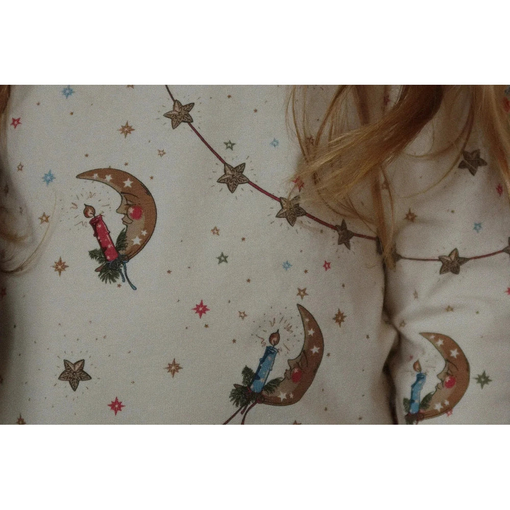 Konges Slojd Holiday Basic Blouse/Pants Set Gots Luna worn by toddler; white fabric with moons, stars, candles.