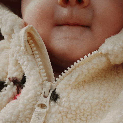 Konges Slojd Jody Teddy Onesie in cream fleece with front zipper for baby