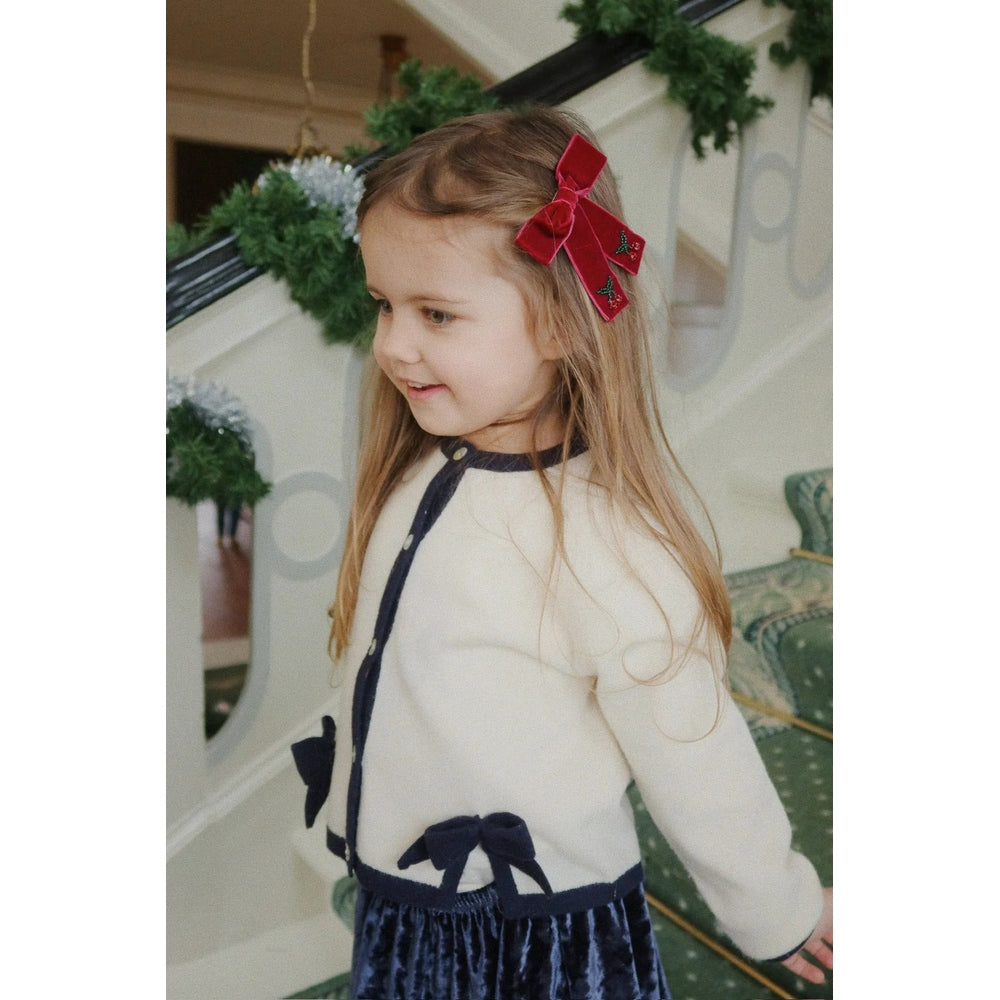 Konges Slojd Juliette Bow Hair Clip 2 Pack Rio Red: a girl wears two red velvet bows clipped in her hair.