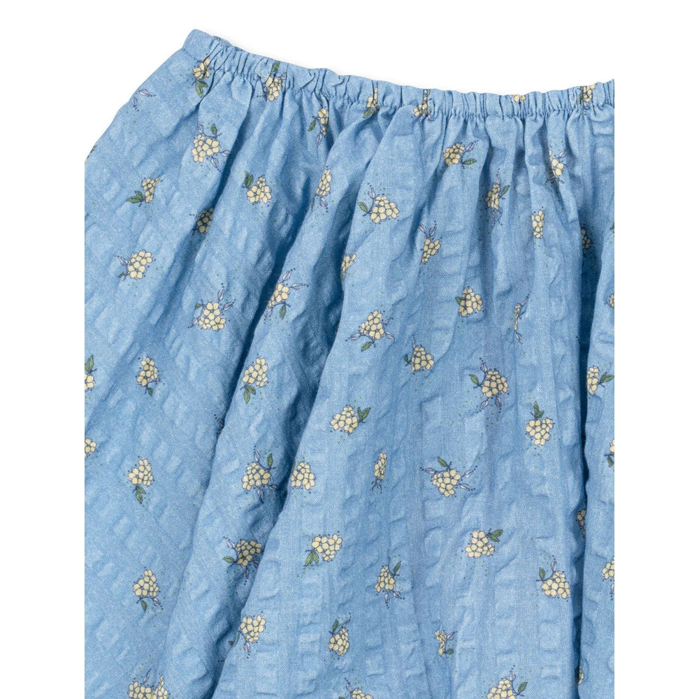 Konges Slojd Kim Skirt Billie Blue: blue cotton skirt with elastic waistband and yellow floral print shown laid flat