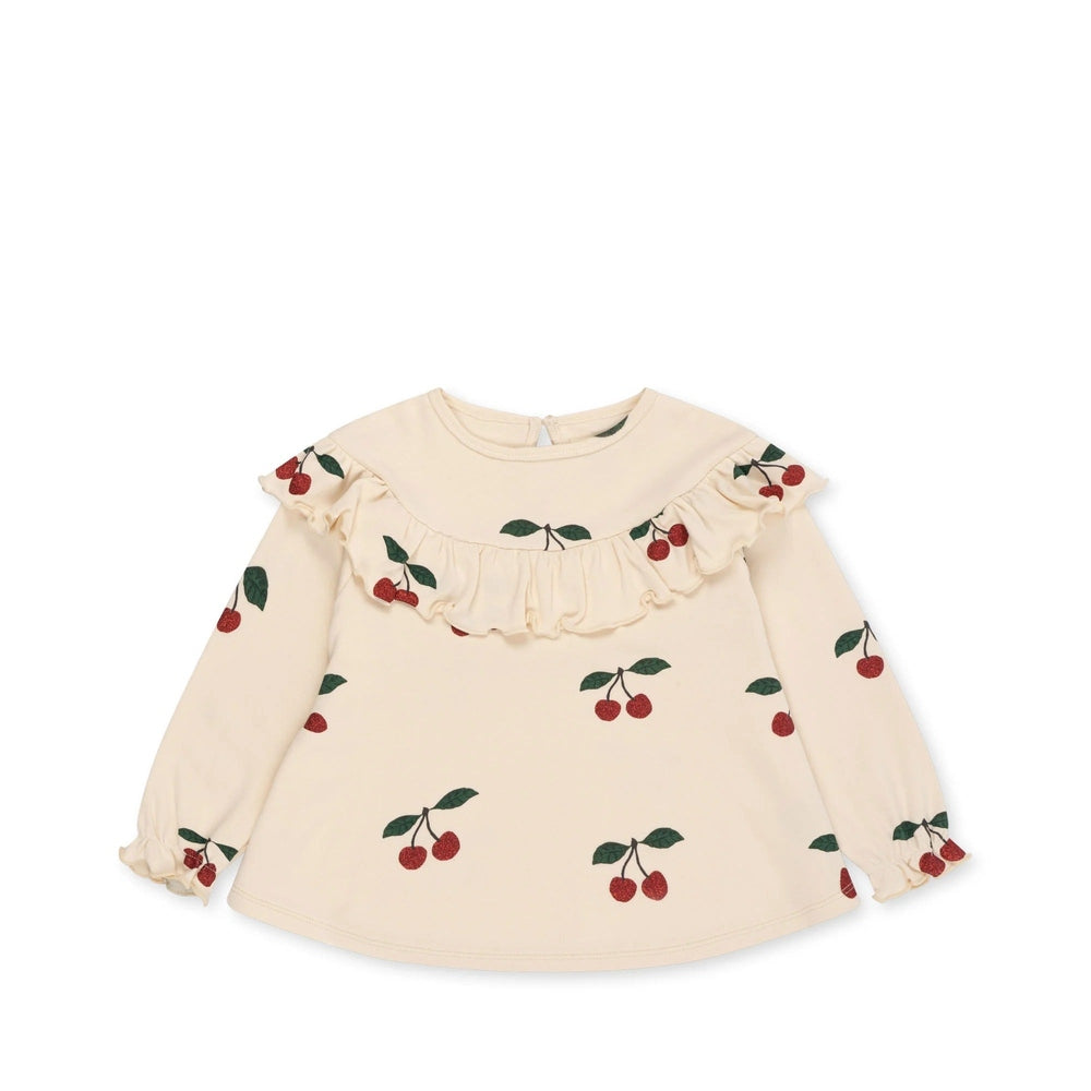 Konges Slojd Malli Glitter Blouse in cream with cherry print, ruffle yoke, and gathered cuffs.