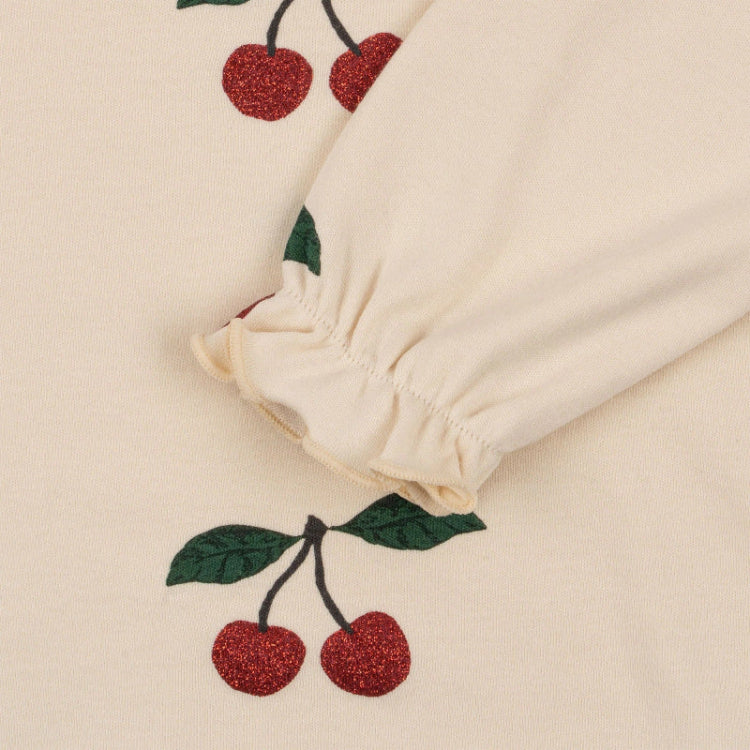 Konges Slojd Malli Glitter Blouse in cream knit with glitter cherries; puffed gathered sleeve cuff.