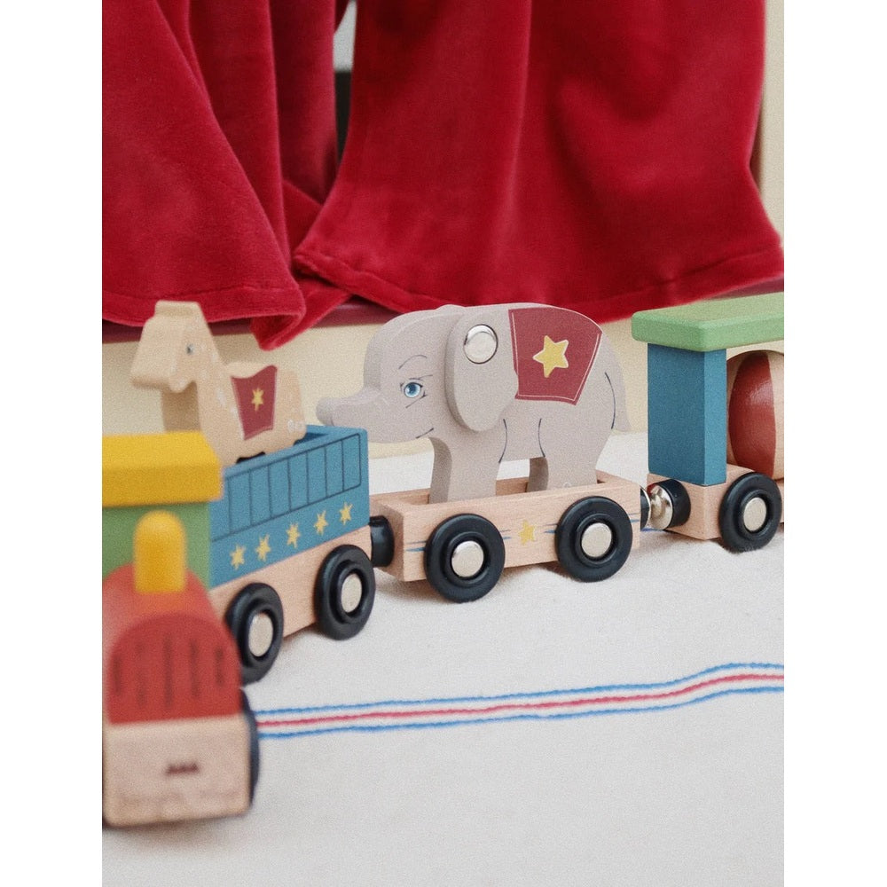 Konges Slojd Matchbox Animals wooden train set with elephant figure pulling colorful cars on a white playmat