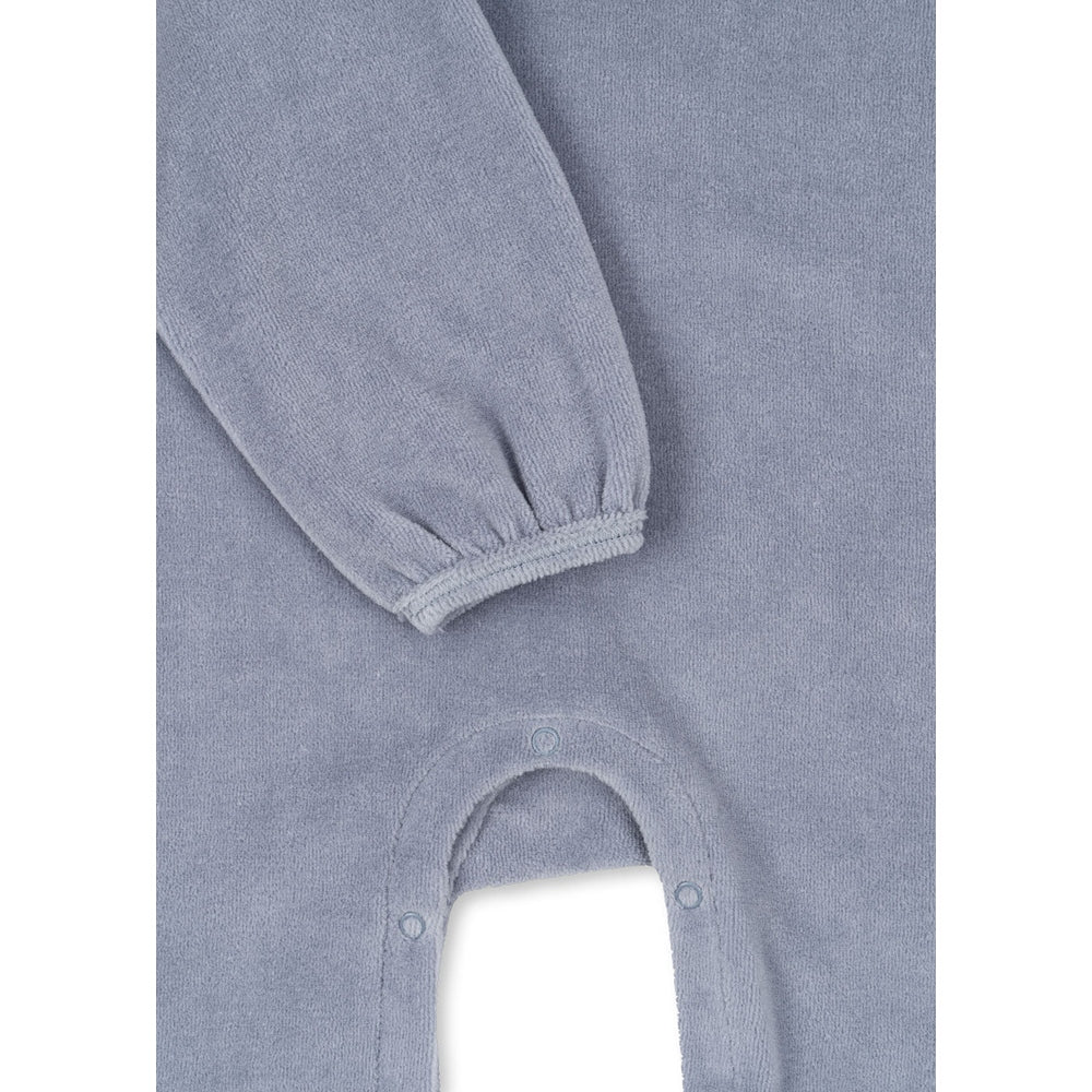 Konges Slojd Miffa Onesie Gots Trade Winds in blue terry, with cuffed sleeves and snap bottom.