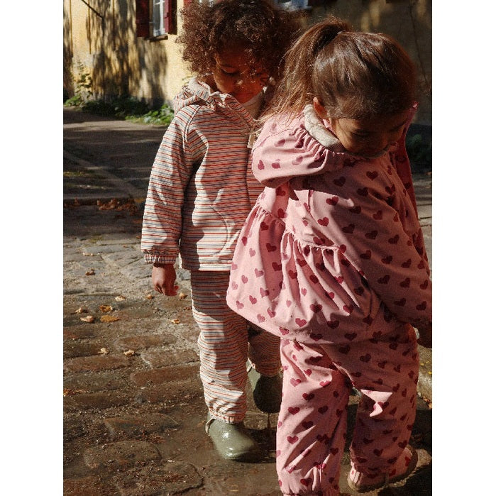Konges Slojd Rainy Palme Set Amour Pink; pink heart-print baby/toddler outfits worn by two kids