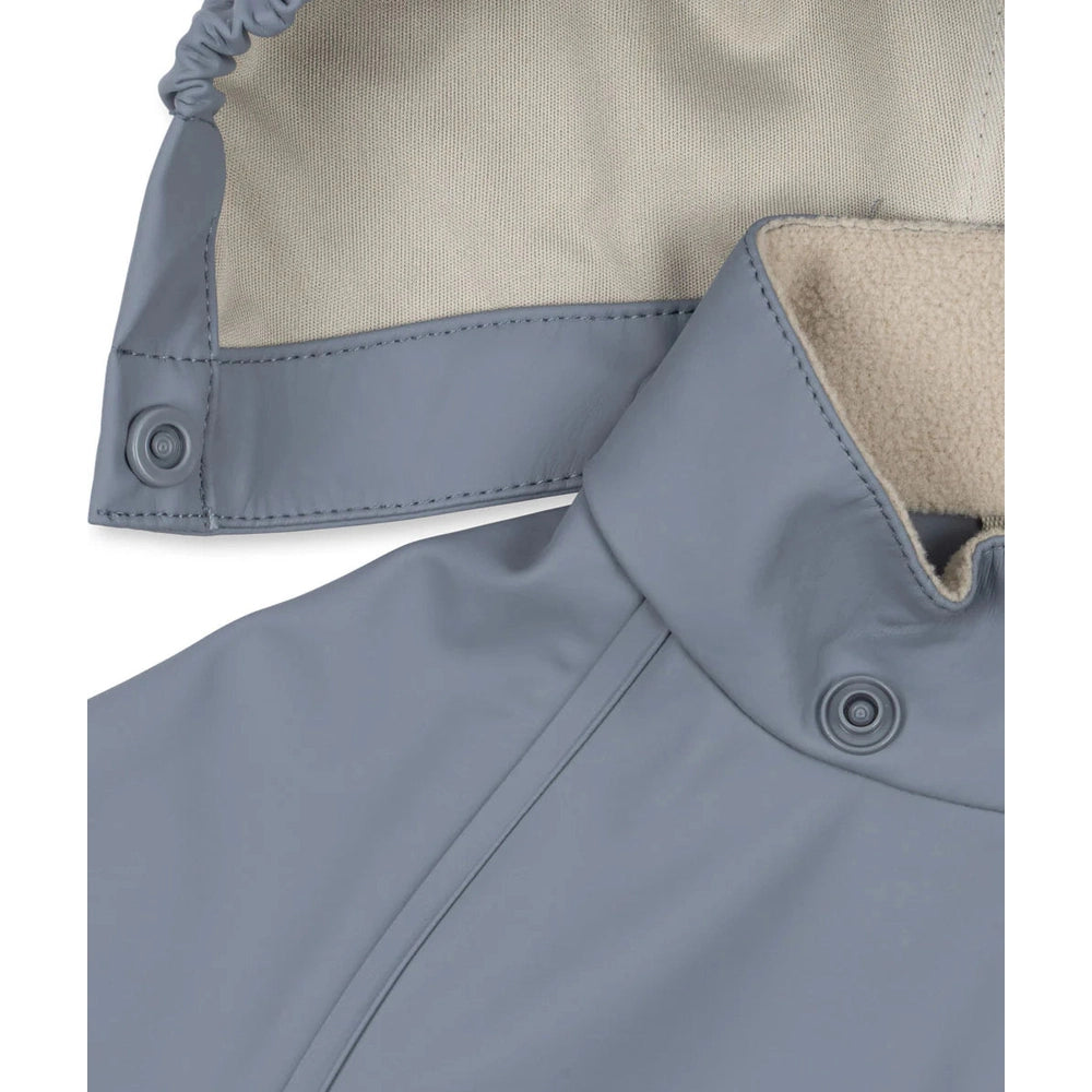 Konges Slojd Sharka Rain Set Tradewinds Rain Set in Tradewinds Blue with beige fleece lining and collar snaps.