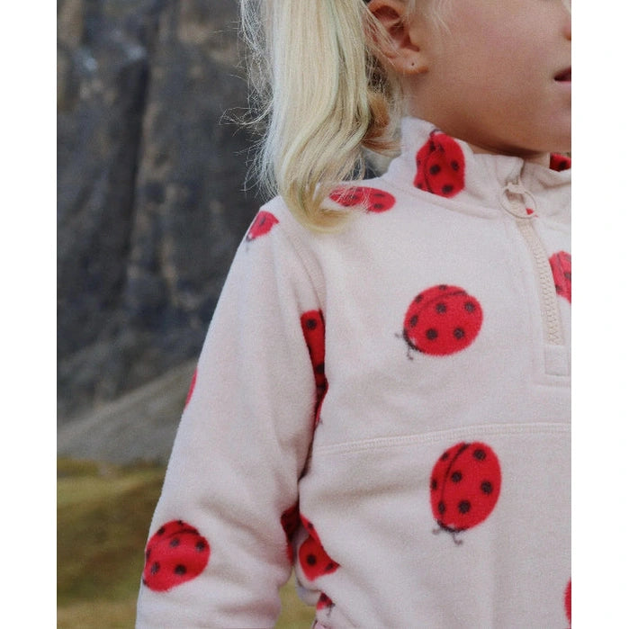 Konges Slojd Tavi fleece sweatshirt for kids in cream with red ladybug prints.