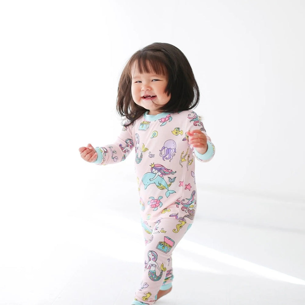 Little Sleepies Bamboo Pajama Set Mermaid for toddlers in pastel pink mermaid print, walking happily.
