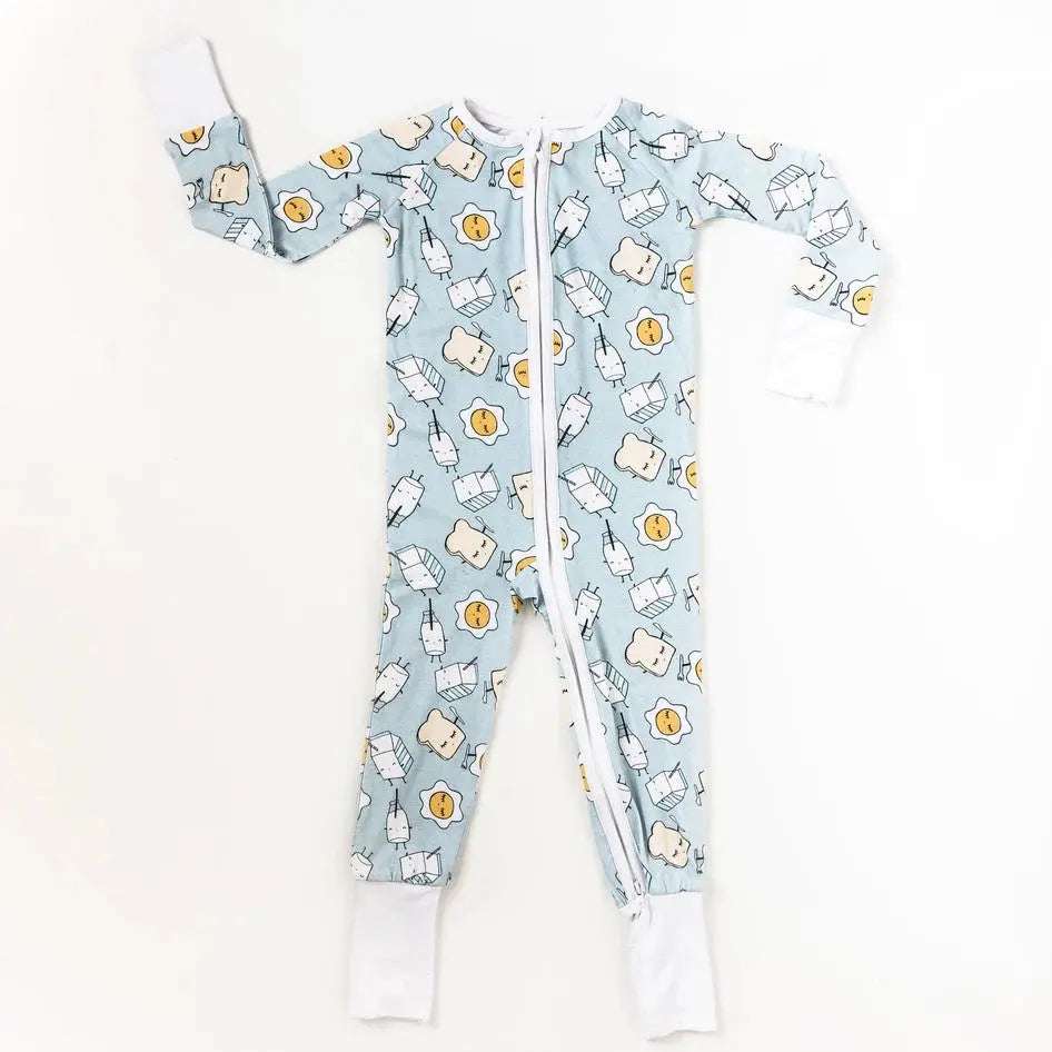 Little Sleepies Bamboo Zip Romper in Blue Breakfast print, laid flat with front zipper and white cuffs.