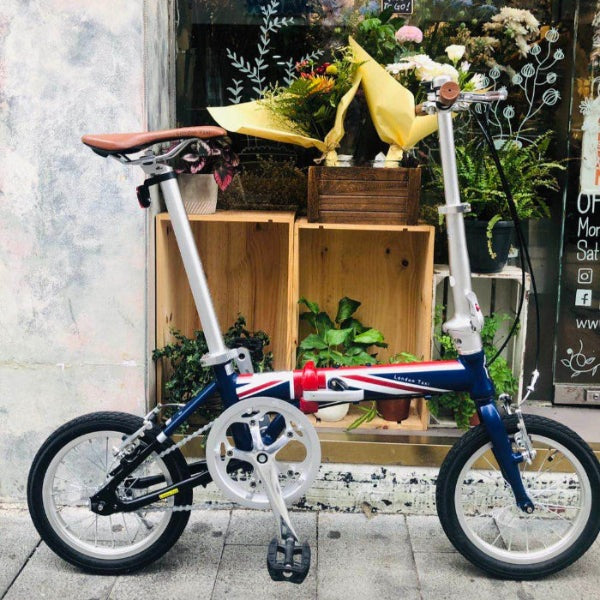 London Taxi folding 14-inch aluminum bicycle with blue front fork, Union Jack accents, and brown saddle
